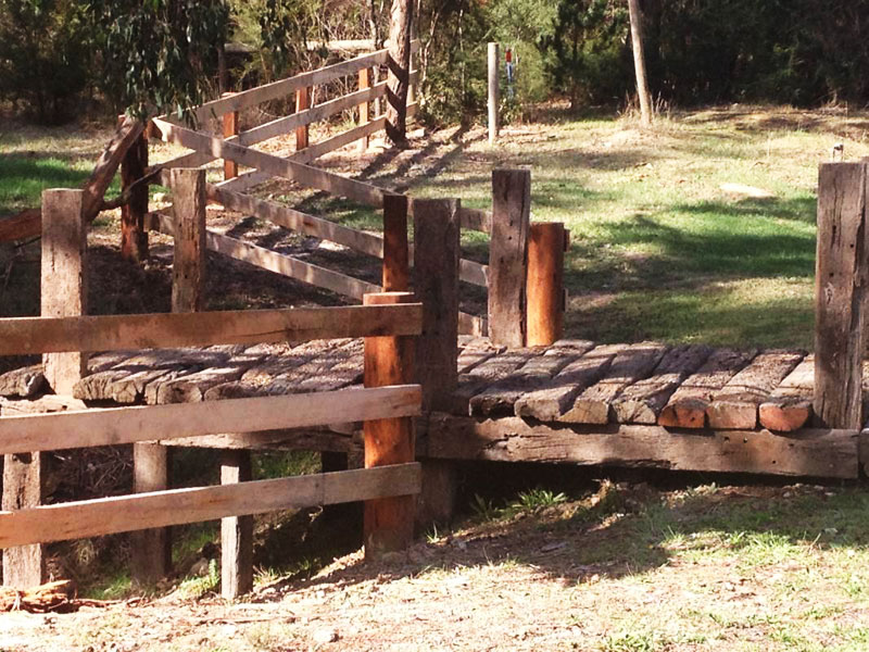 Hardwood post and 3 timber rail fences. Iron bark posts and messmate rails with railway sleeper walkway to dam