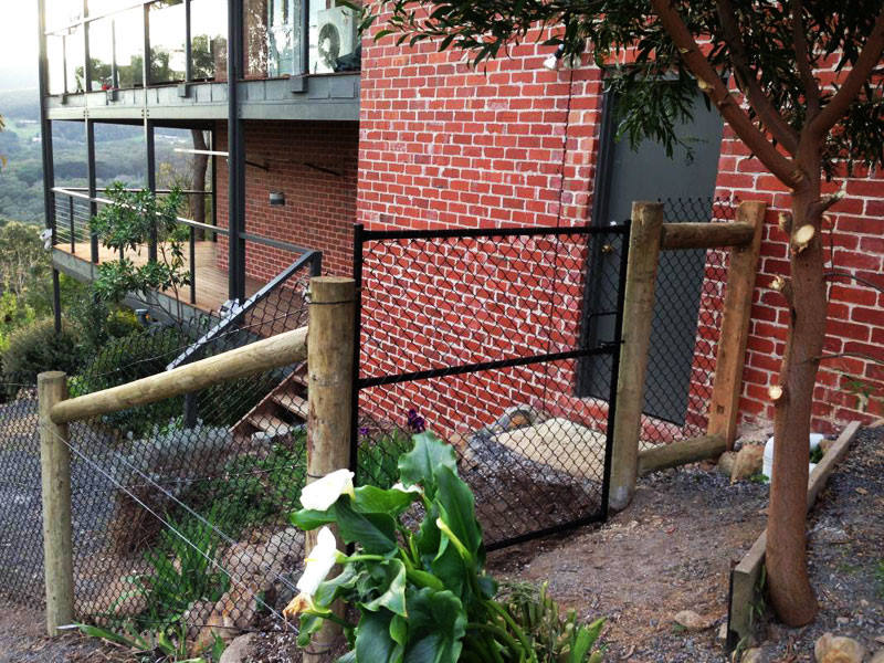pole and wire fencing around house